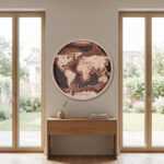 Wooden World Map round wall art above a console table between tall windows in a minimalist entryway