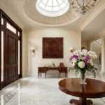 Handcrafted wood wall art featuring an intricate maze design, elegantly displayed in a luxurious foyer setting.