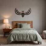 Bird wall art of a spread-wing owl above a wooden bed in a serene bedroom