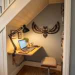 Bird wall art of a flying owl above a compact under-stair home office desk