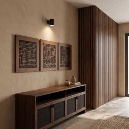 Islamic wall art triptych above a wood console in a modern hallway with slatted walnut paneling